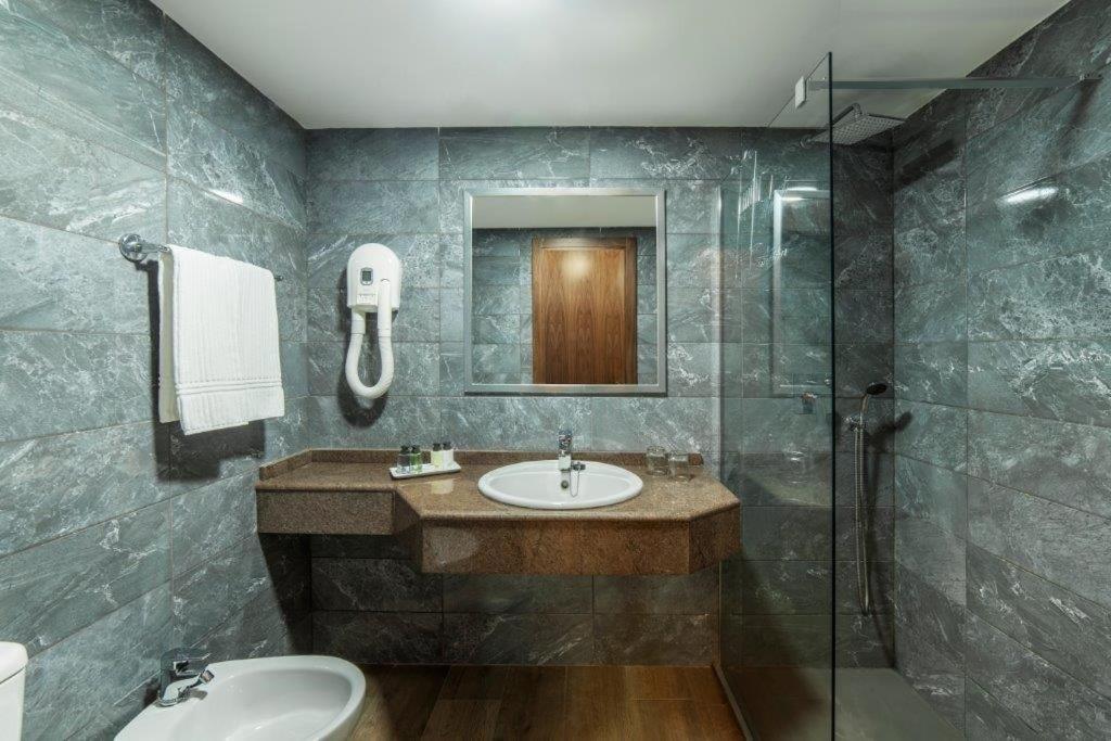 a bathroom with a sink and a shower at Essence Hotel Boutique in Torremolinos