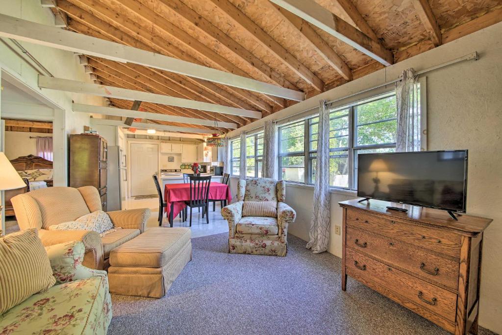 a living room with a flat screen tv and furniture at Rustic Retreat Across from Lake Family Friendly! in Union