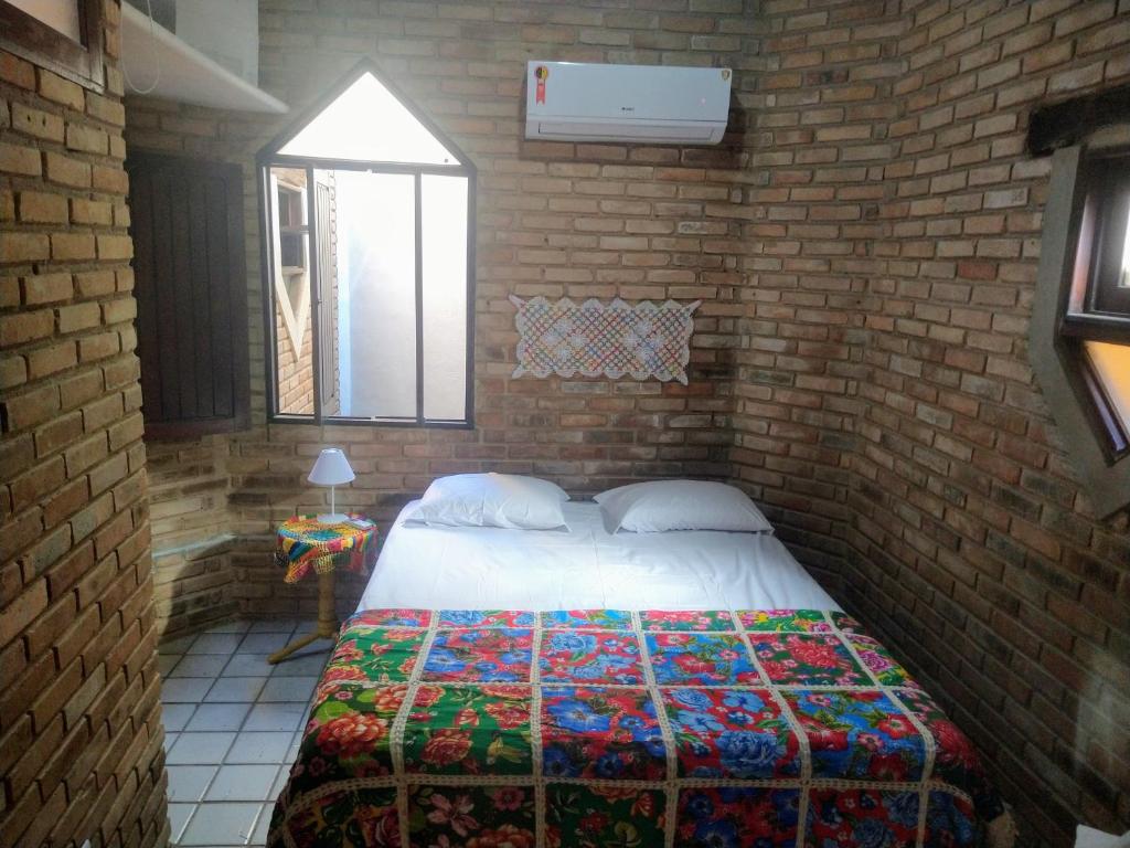 En eller flere senge i et værelse på Apartamento/Duplex Praia do Francês