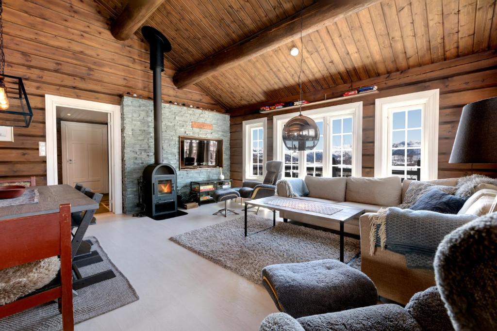 a living room with a couch and a fireplace at Utsikten in Sykkylven