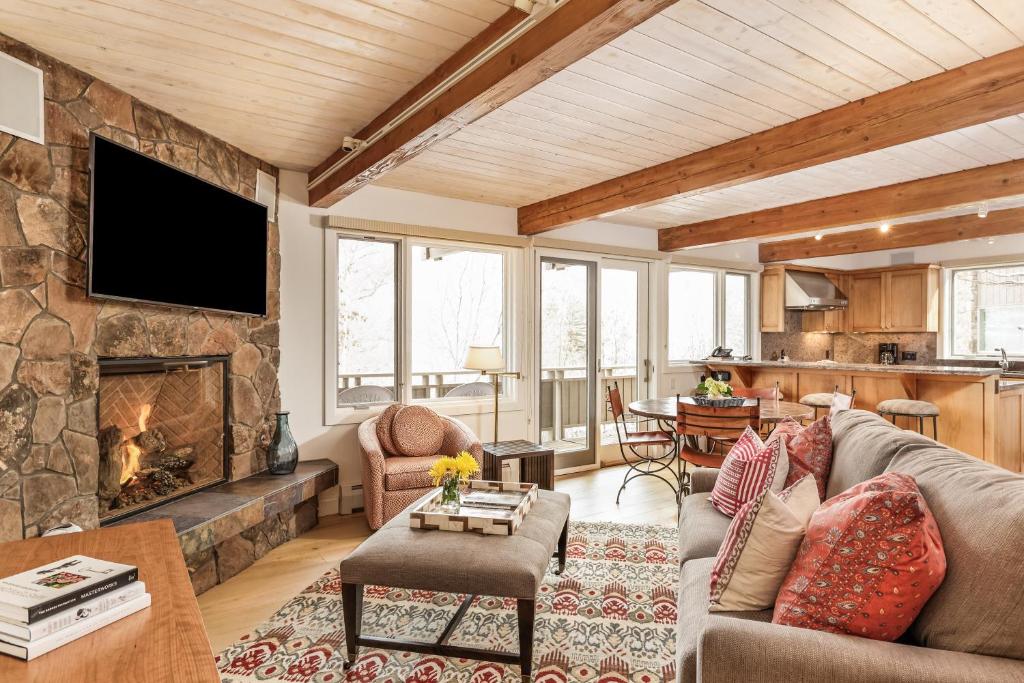 a living room with a couch and a fireplace at Deluxe Two Bedroom - Aspen Alps #504 in Aspen