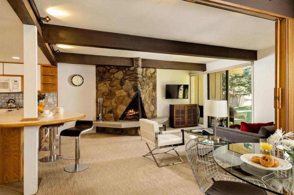 a living room with a table and a fireplace at Standard Two Bedroom - Aspen Alps 101 in Aspen