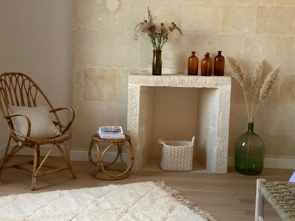 a living room with a chair and a fireplace at Chambres d&#39;hôtes - La Maison 19 in Niort