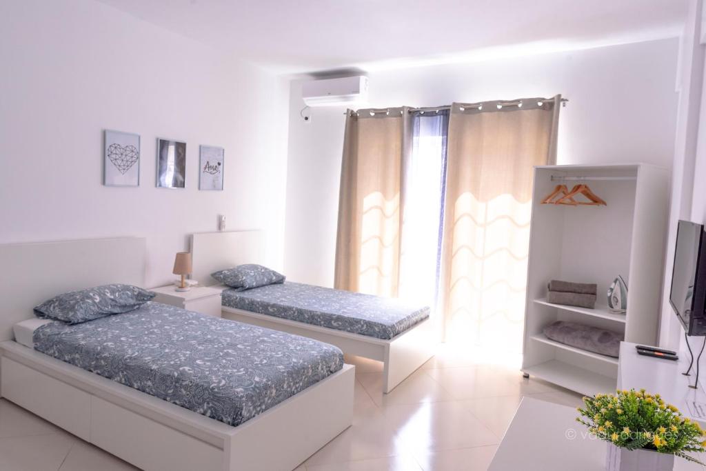 Postel nebo postele na pokoji v ubytování Urban Praia Maria - ApartHotel