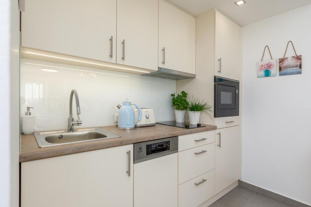 A kitchen or kitchenette at VeronikApartman - brand new & cozy - with underground garage