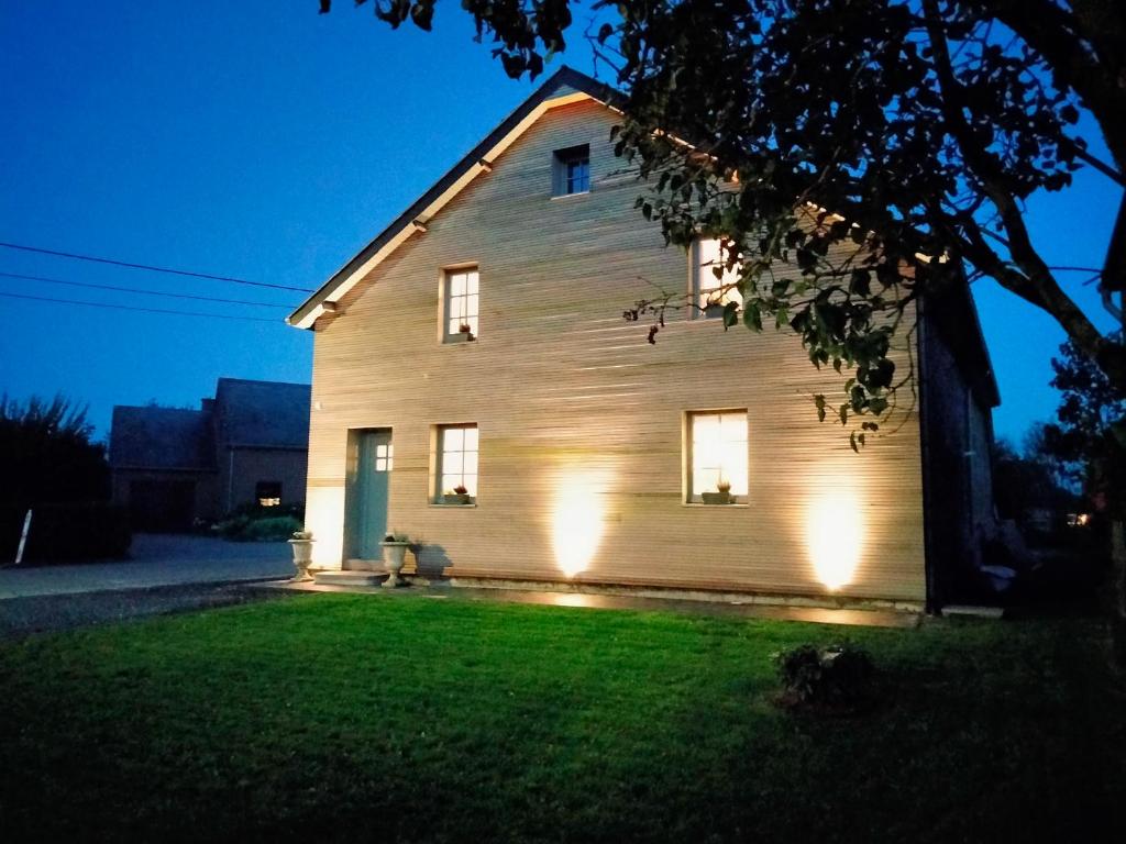 a house with lights on the side of it at night at Le refuge de Julia in La-Roche-en-Ardenne