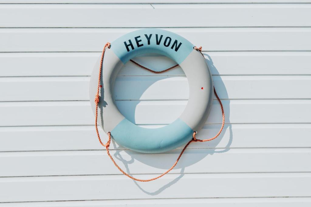 a blue and white lifesaver hanging on a wall at Houseboat Heyvon in Bembridge