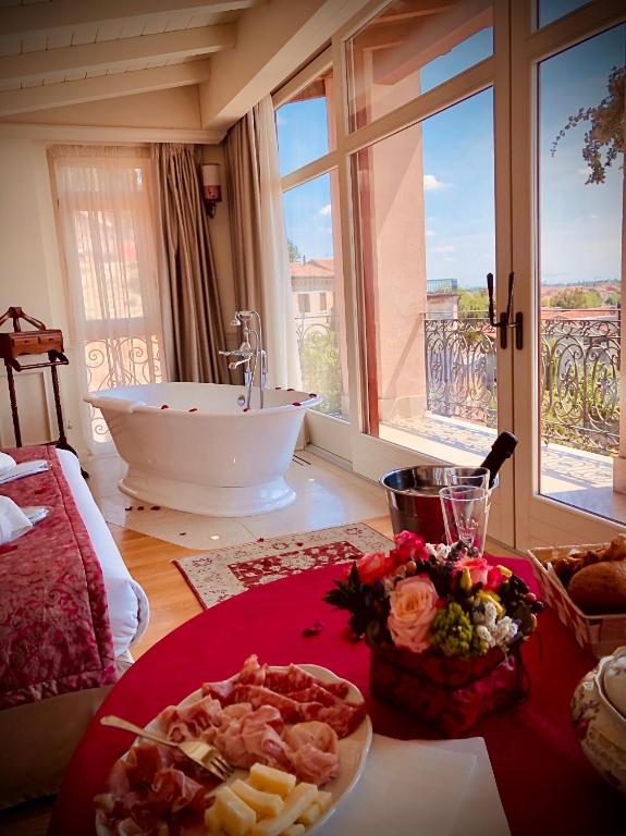 a bathroom with a bath tub and a plate of food at Relais Colle San Pietro in Verona