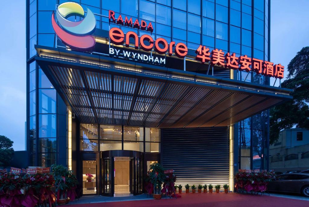a building with a sign on top of it at Ramada Encore by Wyndham Dongguan East in Dongguan