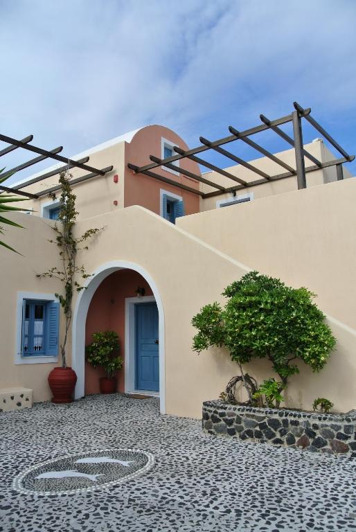 a building with a pathway leading to the front of it at Anemoessa Villa in Oia
