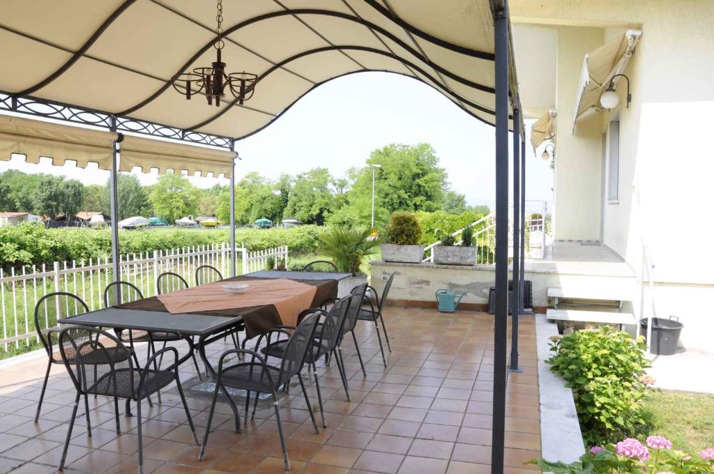 a patio with a table and chairs under a pergola at Apartment in Lazise - Gardasee 41952 in Lazise