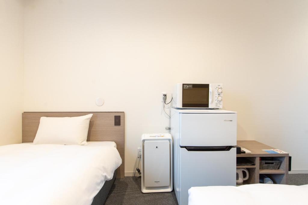 Postel nebo postele na pokoji v ubytování HOTEL R9 The Yard Hitachinaka