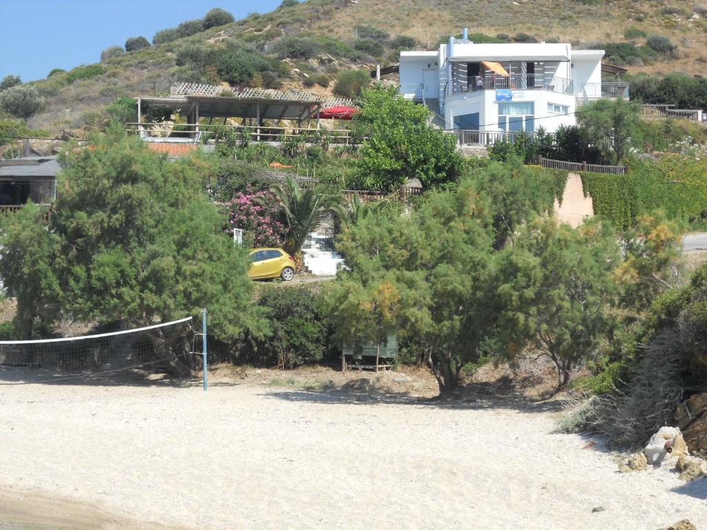 a house on top of a hill with trees at Bel Mare in Agioi Apostoli