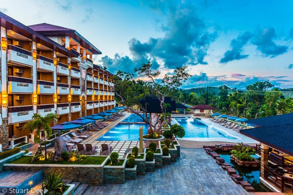 an image of a hotel with a swimming pool at Coron Westown Resort in Coron