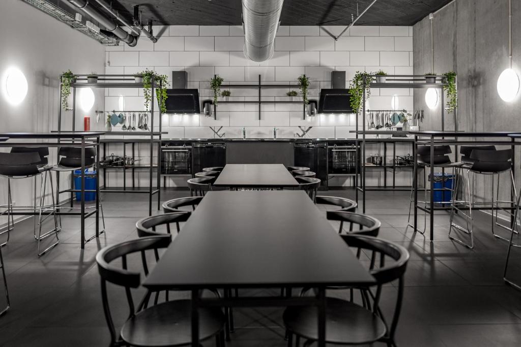 an empty room with tables and chairs and plants at Cabinn Copenhagen in Copenhagen