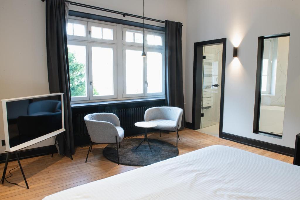 Postel nebo postele na pokoji v ubytování JAMES Résidence & Spa