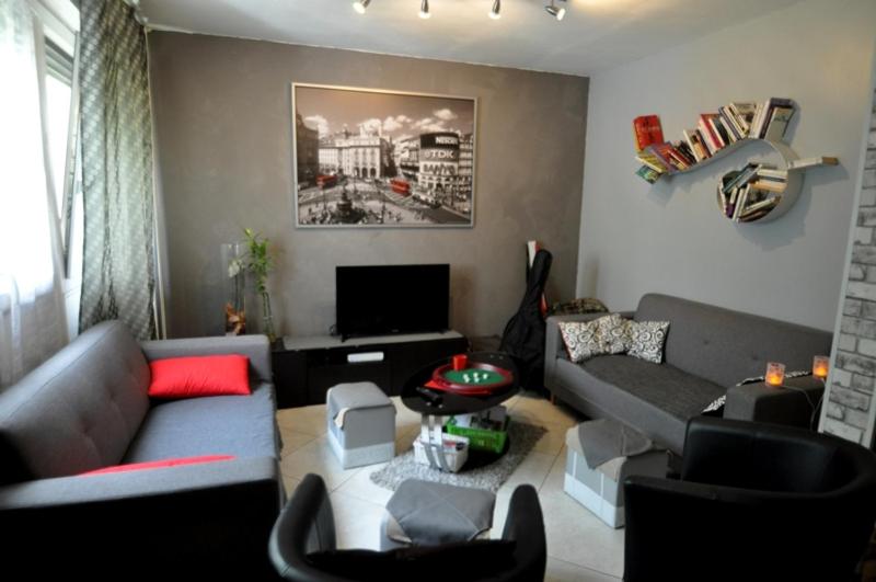 a living room with a couch and a tv at L'auberge des travailleurs in Échirolles