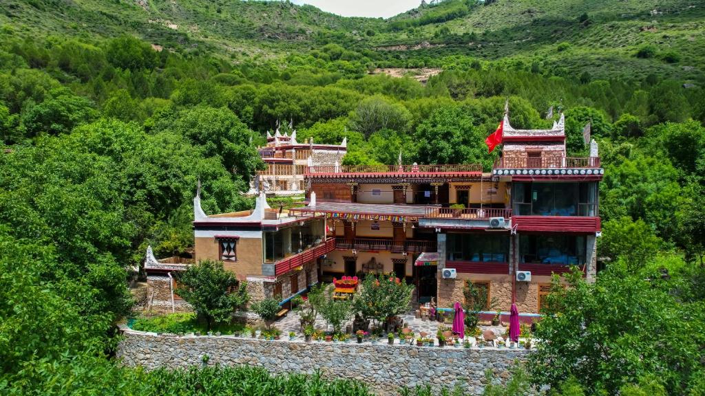 una casa grande en medio de una montaña en Jiaju Legend Homestay, en Danba