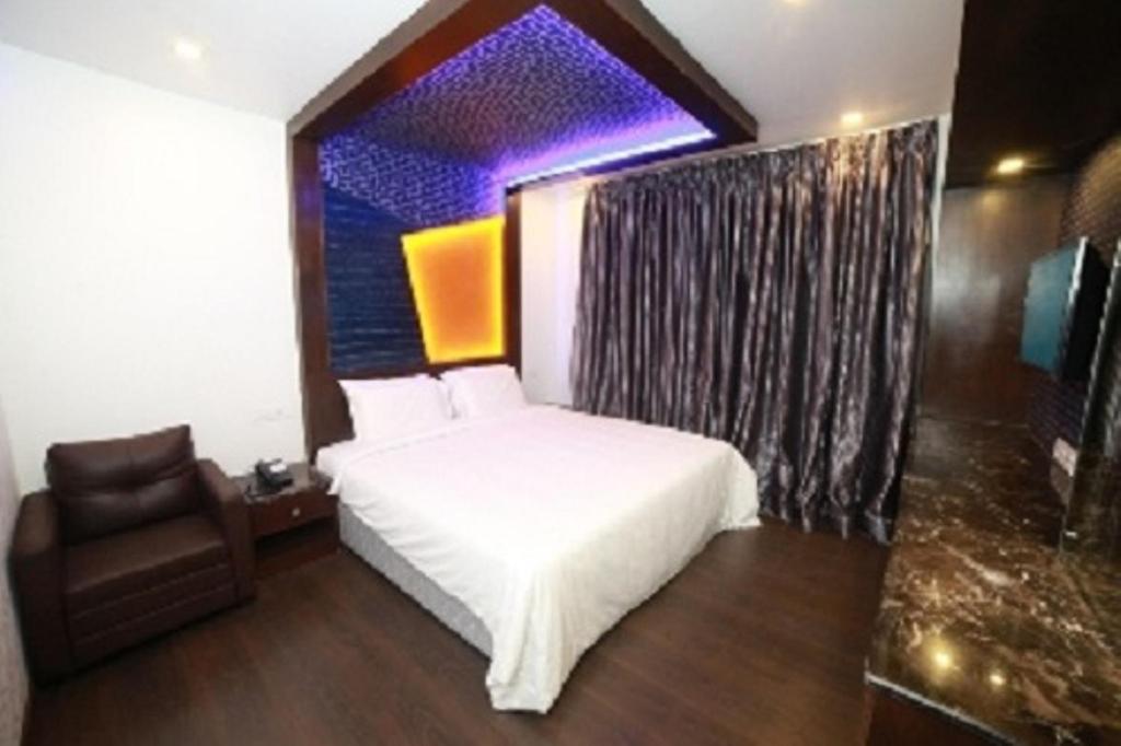 Postel nebo postele na pokoji v ubytování Hotel M Grand