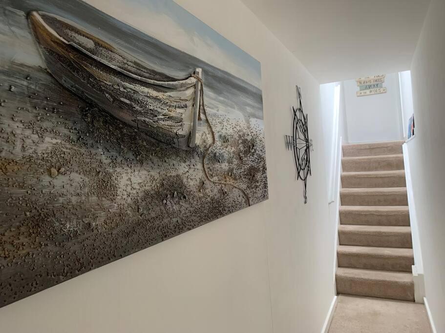 a painting of a boat hanging on a wall at Lovely 2 bedroom modern loft apartment sea view in Morecambe