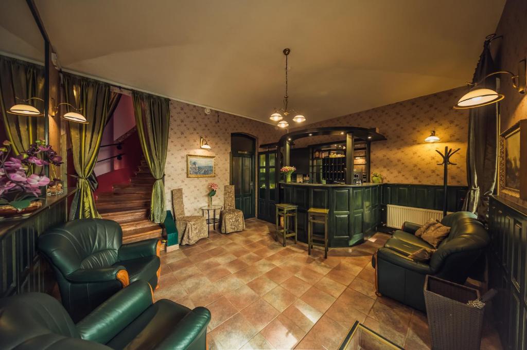 a living room with couches and a bar at Hotel Czechia in Prague
