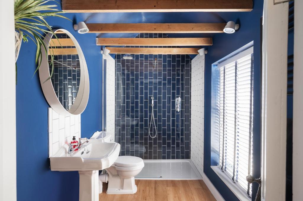 a bathroom with a toilet and a sink and a shower at Worthing town house in Worthing