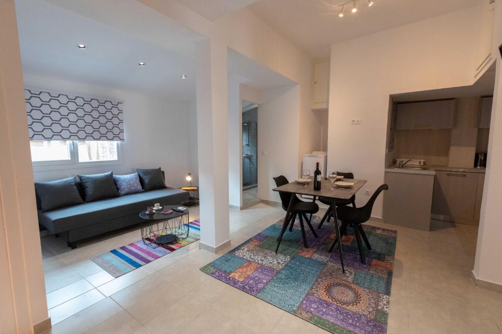 a living room with a table and a couch at Athenian Port Luxury Apartment 2/Piraeus Riviera in Piraeus