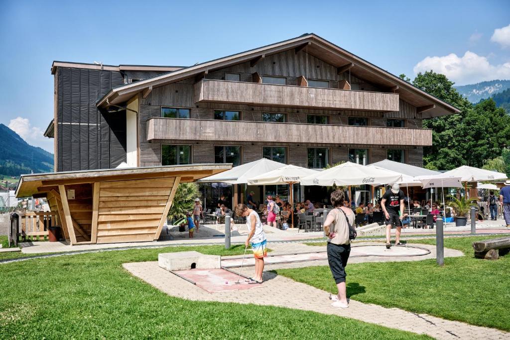 a group of people standing in front of a building at Frutigresort in Frutigen