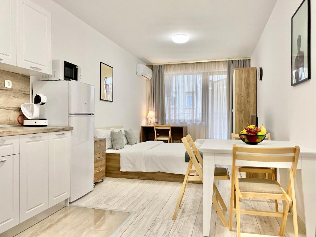 a kitchen and dining room with a bed and a table at Cozy Studio next to State Opera with Work Space in Stara Zagora