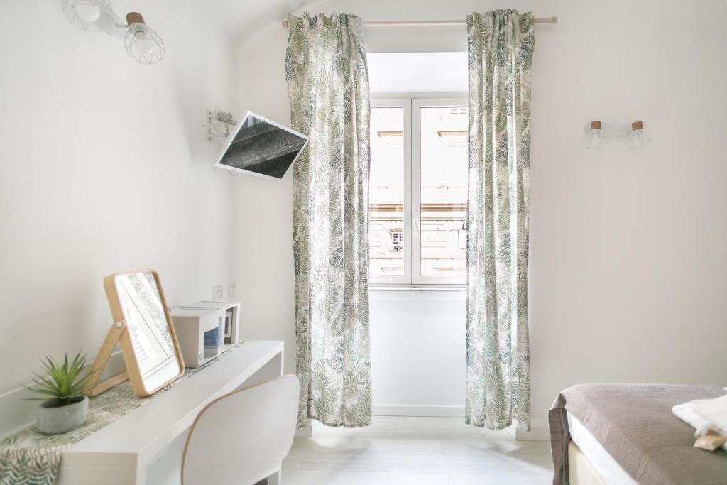 Televízia a/alebo spoločenská miestnosť v ubytovaní White Candia Guesthouse