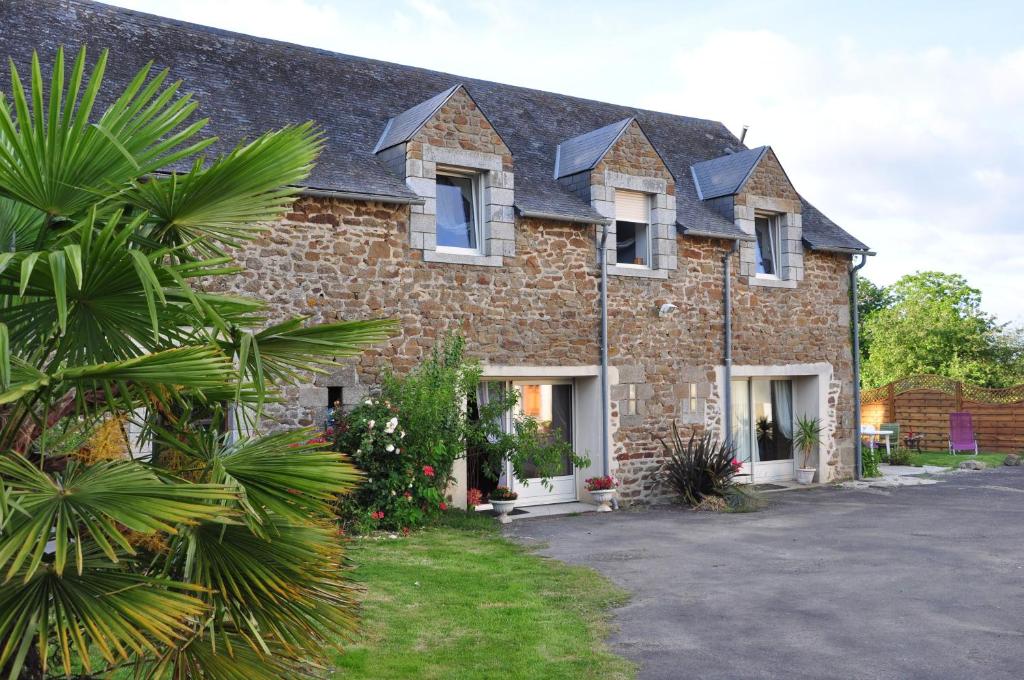 a large brick building with windows and a driveway at La Grande Malardiere in Saint-Georges-Buttavent