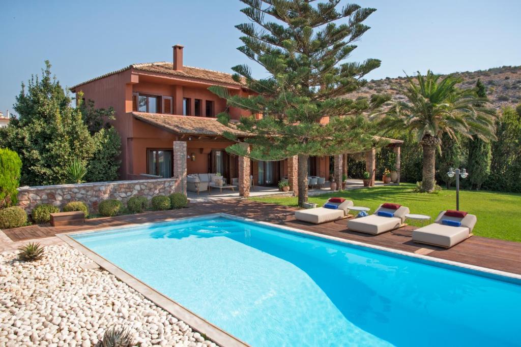 a villa with a swimming pool and a house at Villa Terra Mare in Vari