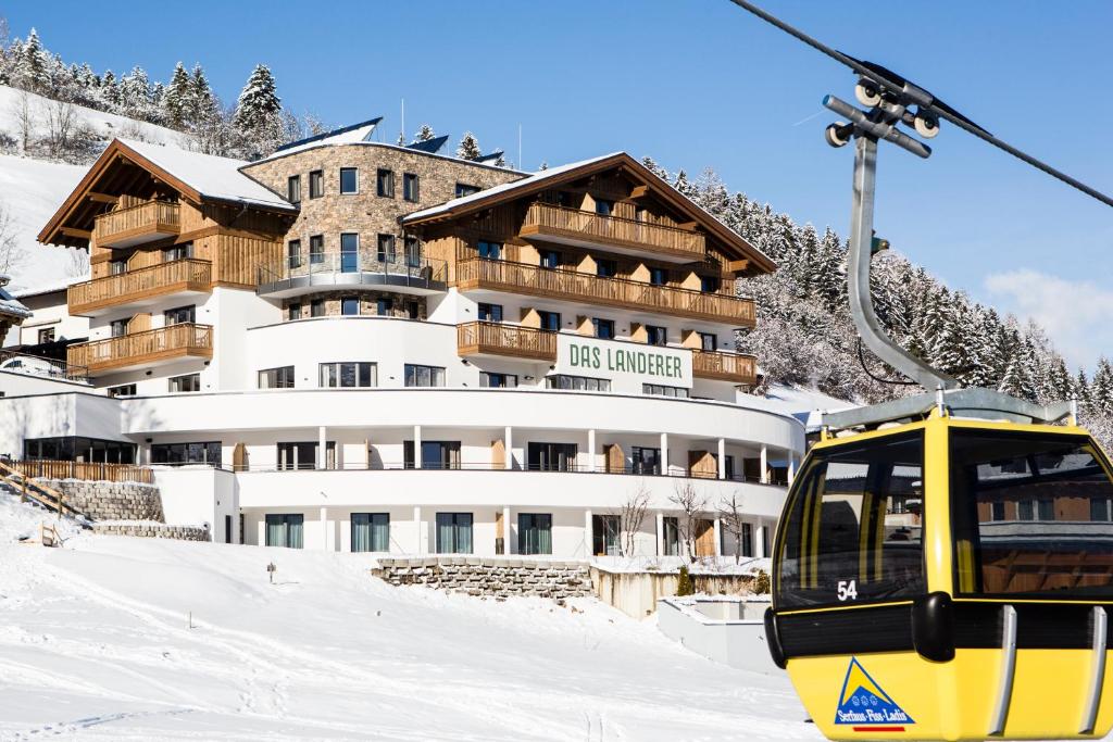 a ski lift in front of a building in the snow at Das Landerer in Ladis