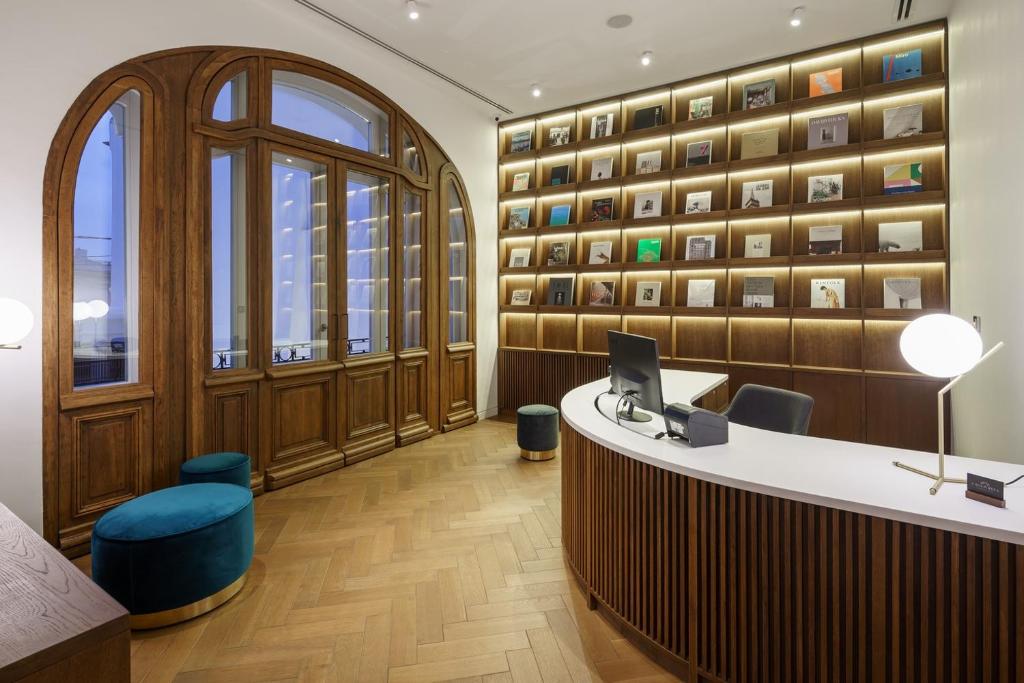 a lobby with a desk with a computer on it at Casa Popeea Boutique Hotel in Brăila