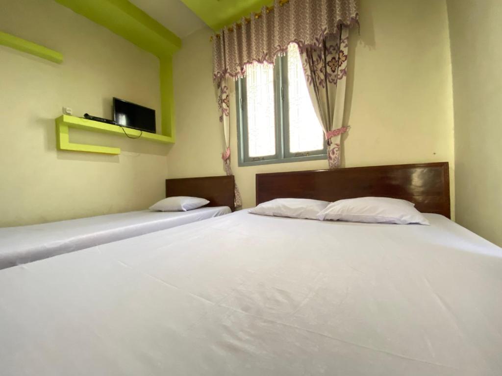 Postel nebo postele na pokoji v ubytování Homestay Srikandi Syariah Dieng RedPartner