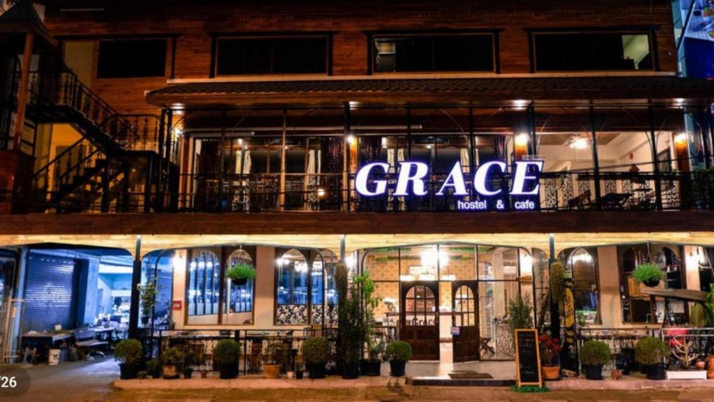 a store front with a large sign that reads garage at Grace hostel - Chiang Rai in Chiang Rai