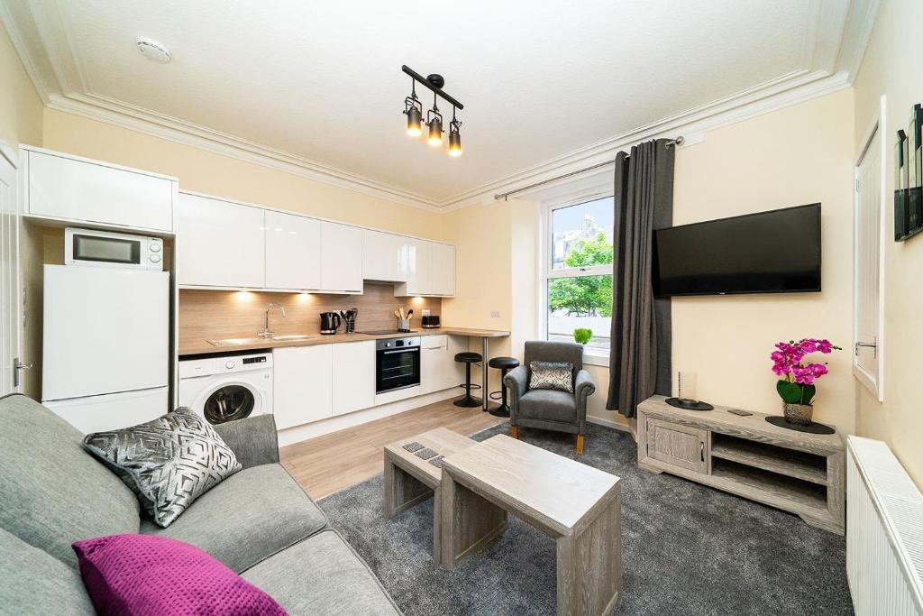 a living room with a couch and a table at Rosemount Residence in Aberdeen