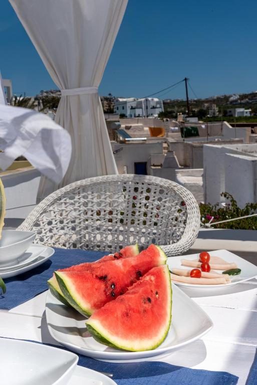 two slices of watermelon on plates on a table at Villa Orpheus Santorini in Megalokhori