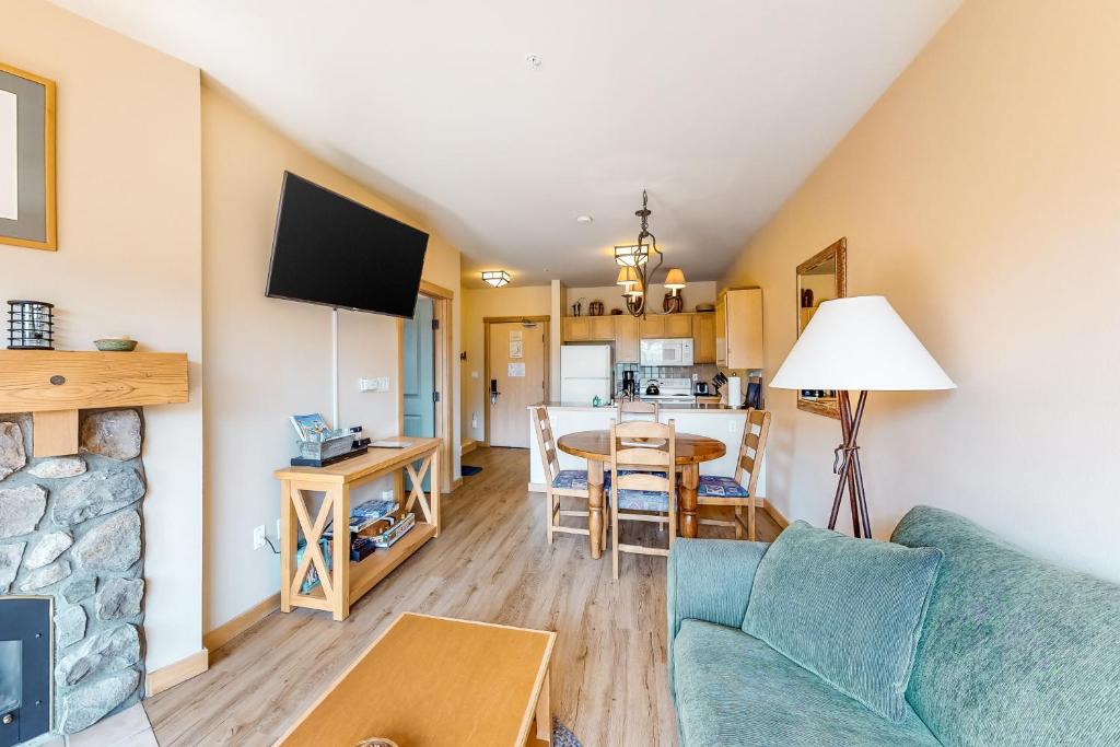 a living room with a couch and a table at Juniper Springs 444 in Mammoth Lakes