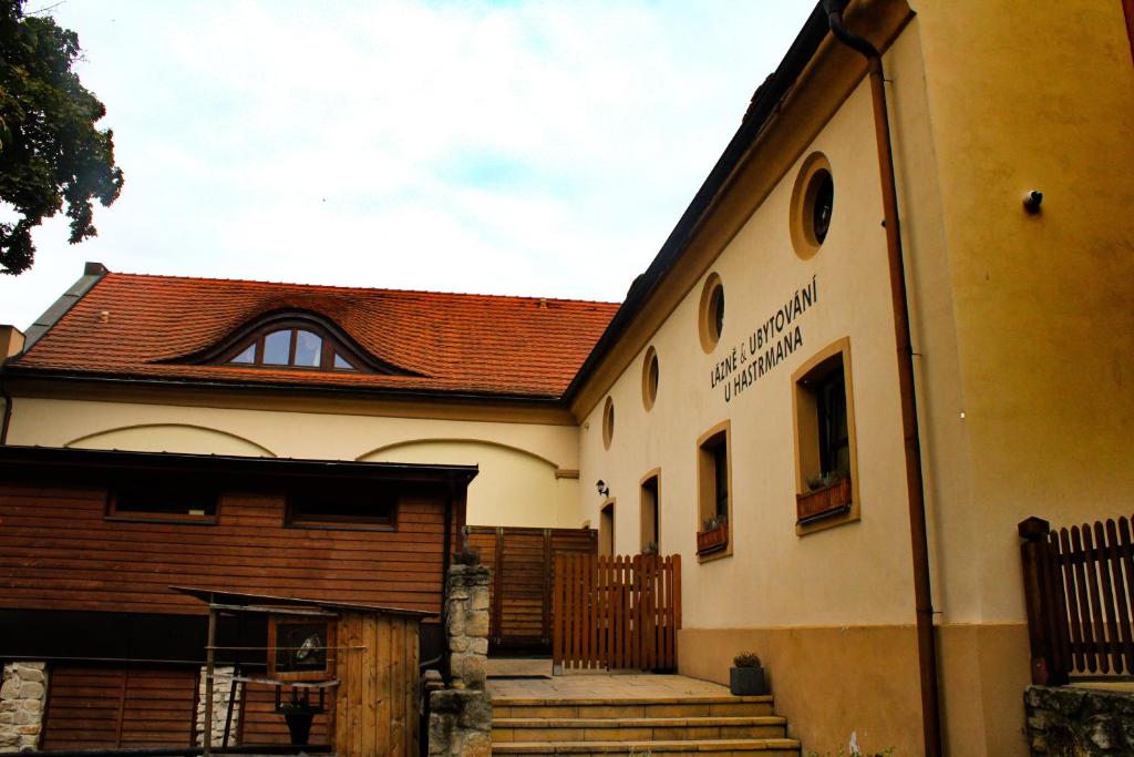 a building with a gate and stairs in front of it at Pension U Hastrmana in Prague