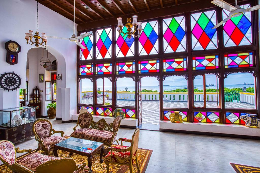 a living room with colorful stained glass windows at Tembo House Hotel in Zanzibar City