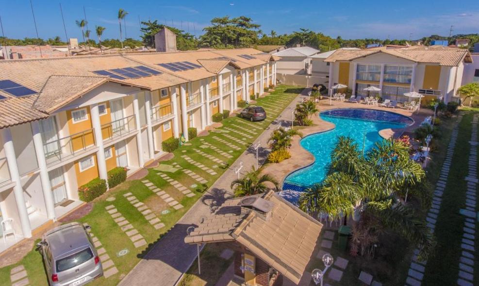 an aerial view of a resort with a swimming pool at STUDIO Mont Carmelo BA in Porto Seguro