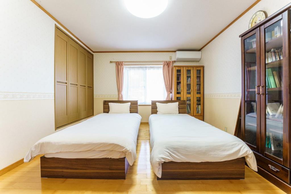 Postel nebo postele na pokoji v ubytování Bunzaemon