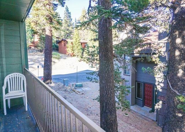 a white chair sitting on the porch of a house at St Anton Courtyard View Ski-In and Out 1 Bedroom Condo in Mammoth Lakes