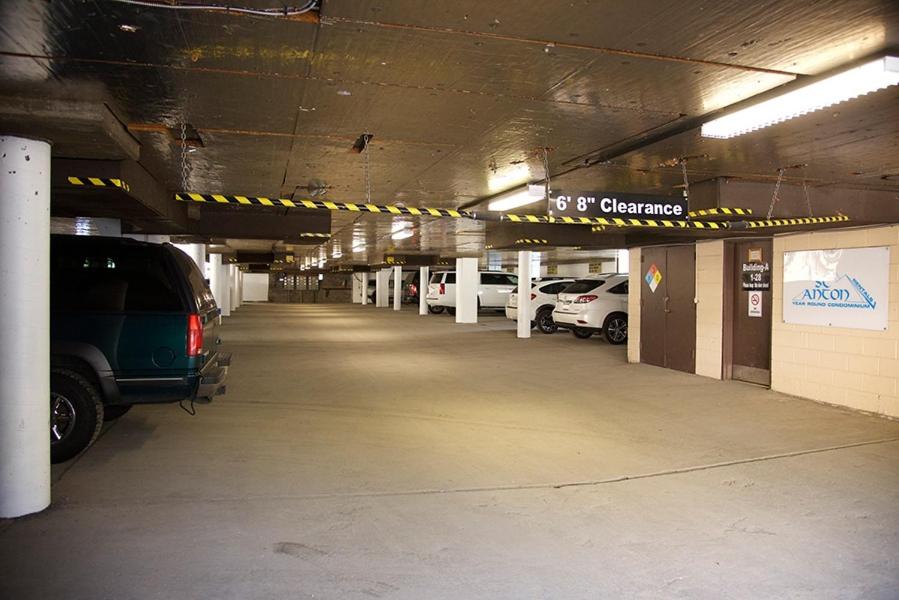 a parking lot with cars parked in a parking garage at St Anton Condos with Rec Center in Mammoth Lakes