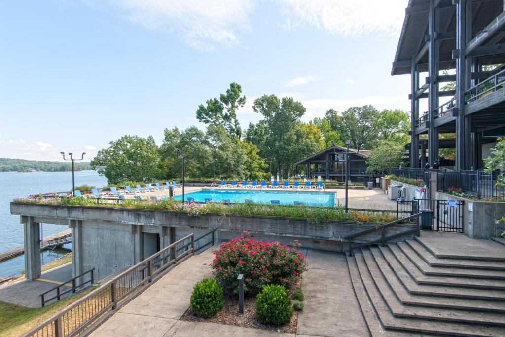 a swimming pool at a resort next to the water at Lake Barkley State Resort Park in Cadiz