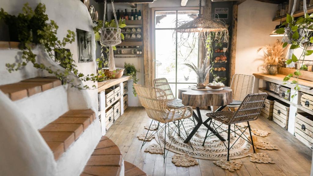 a room with chairs and a table and a window at Nooks by AdyBeca - Balnaca Traditional Nook in Bălnaca