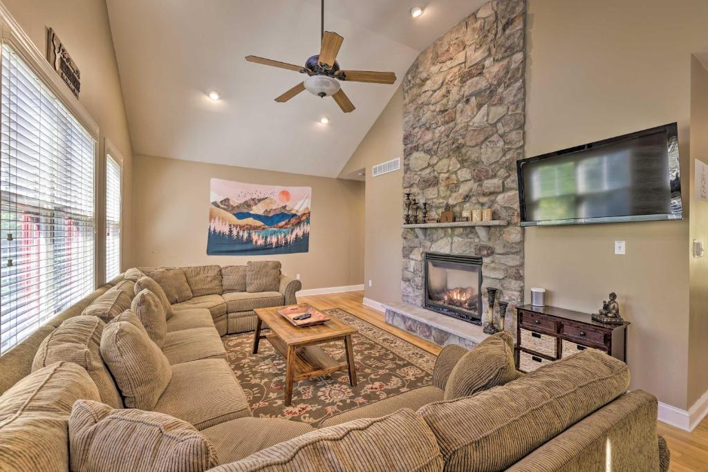 a living room with a couch and a fireplace at Less Than Half-Mi to Skiing Lake Harmony Home with Hot Tub in Lake Harmony