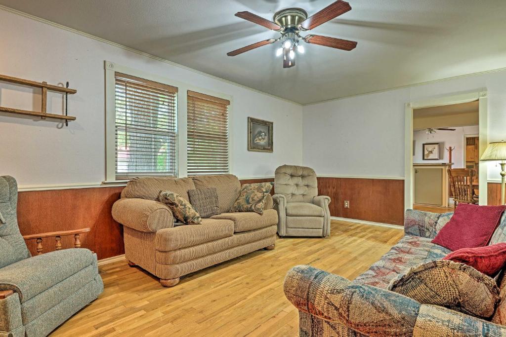 a living room with couches and a ceiling fan at Llano Home with Yard Walk to Restaurants! in Llano