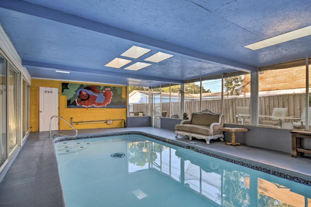 a large swimming pool with a couch and a chair at Vibrant St Petersburg Home with Private Yard! in Bay Pines